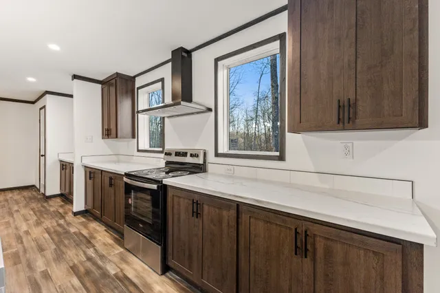 a kitchen with stainless steel appliances granite countertop a stove and a sink