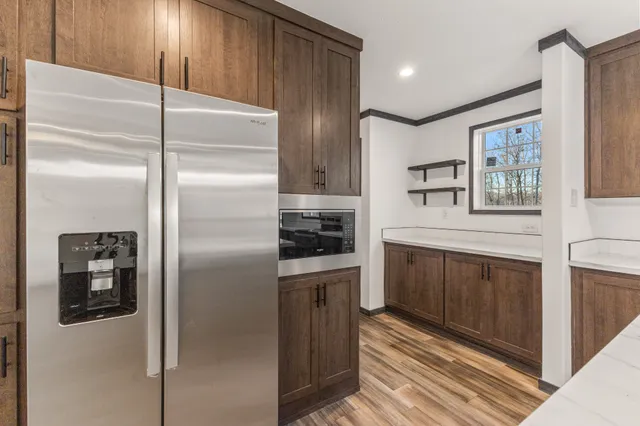 a kitchen with stainless steel appliances granite countertop a refrigerator and a stove