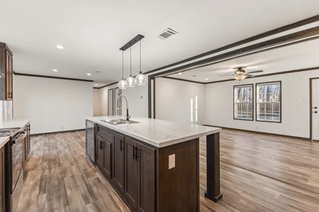 a kitchen with a stove and a wooden floor