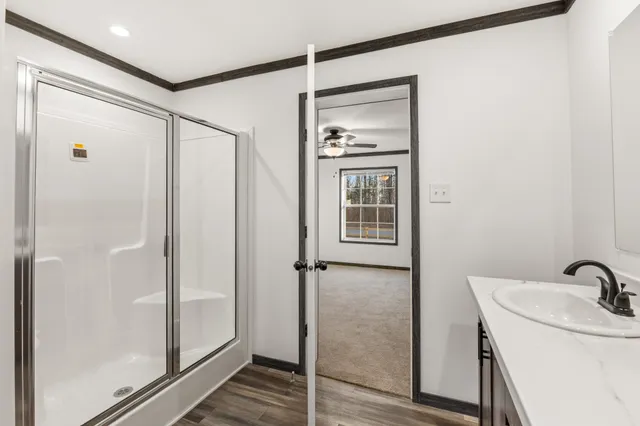 a bathroom with a shower and a sink