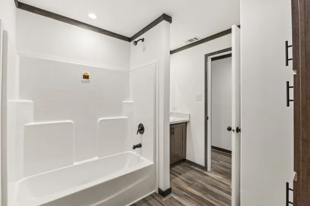 a bathroom with a bathtub and a shower