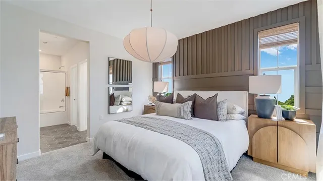 a spacious bedroom with bed and a window