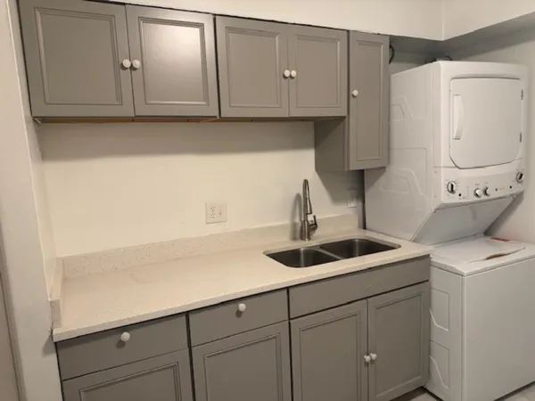 a kitchen with a sink and cabinets