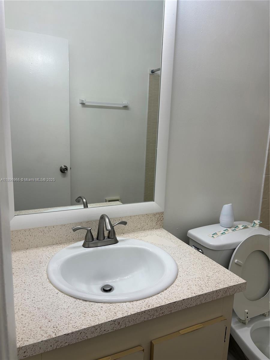 3629 Inverrary Boulevard West Lauderhill, FL 33319 - Photo 12 of 16 a bathroom with a sink and a mirror