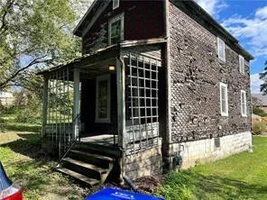 a view of house with backyard