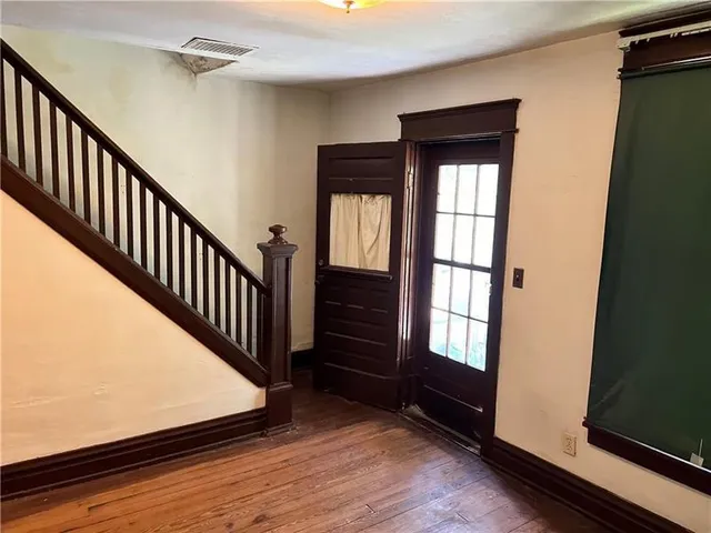 a view of entryway and hall with wooden floor
