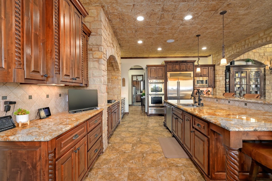 1298 Mystic Parkway Spring Branch, TX 78070 - Photo 11 of 40 a large kitchen with kitchen island granite countertop a sink and a stove