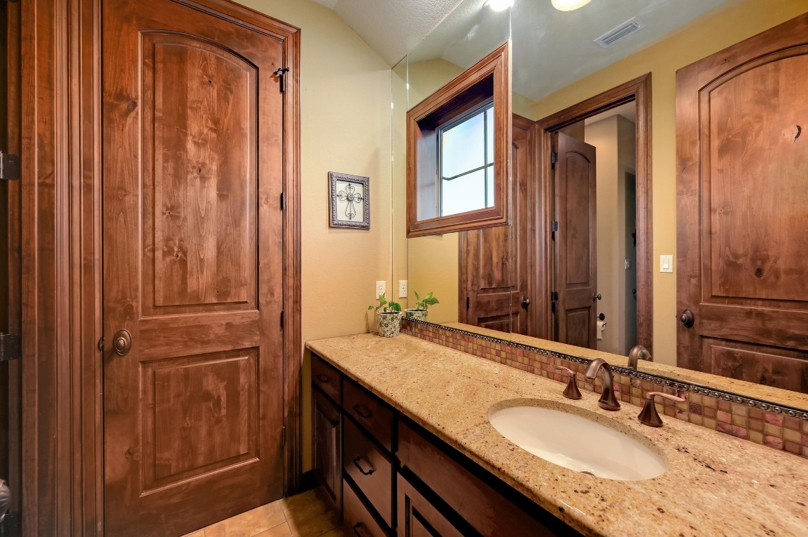 1298 Mystic Parkway Spring Branch, TX 78070 - Photo 26 of 40 a bathroom with a granite countertop sink and a mirror