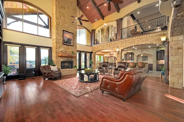 a living room with furniture a rug and a book shelf