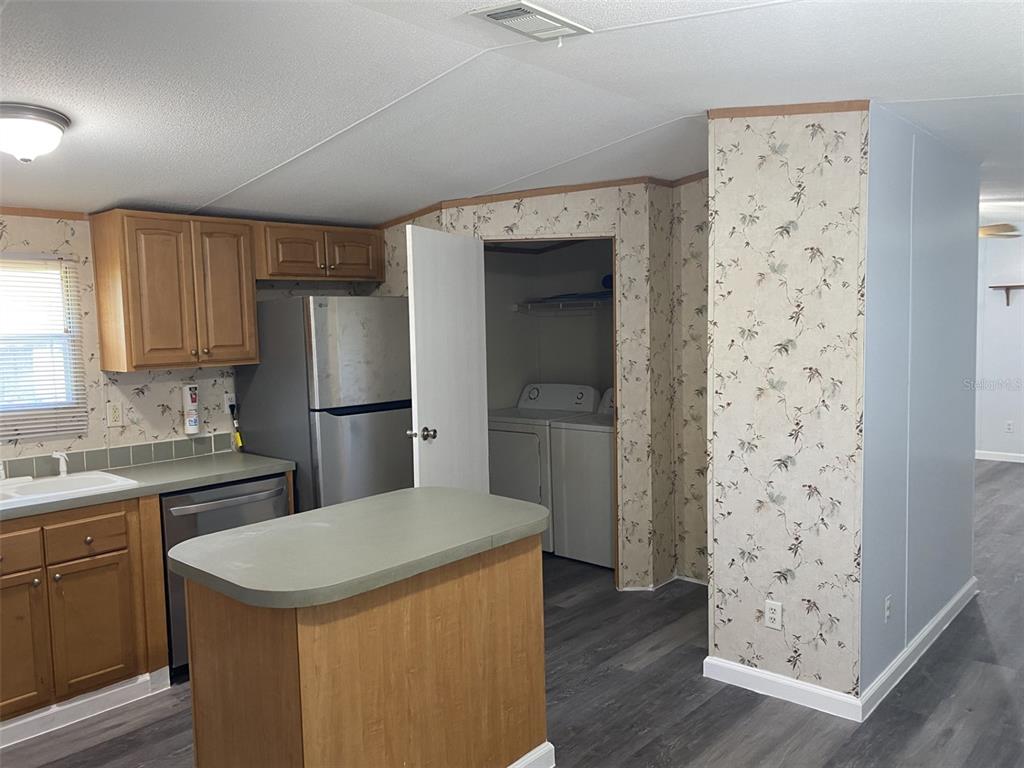 1604 Vintage Street Kissimmee, FL 34746 - Photo 11 of 23 a kitchen with a refrigerator and a sink