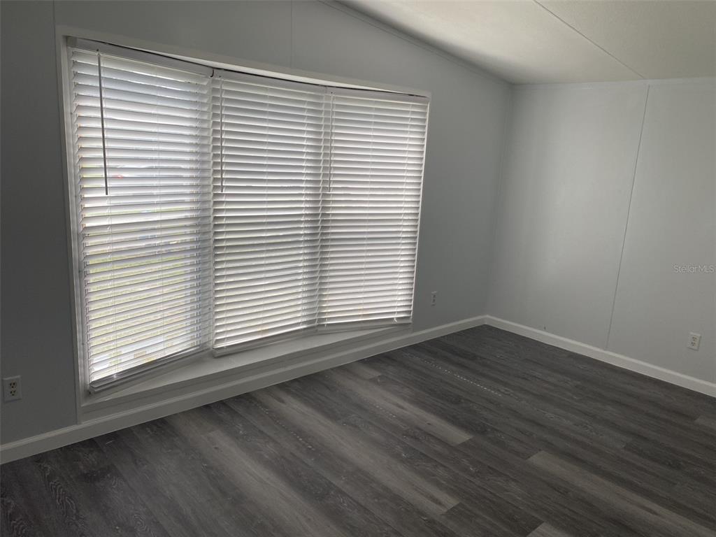 1604 Vintage Street Kissimmee, FL 34746 - Photo 14 of 23 an empty room with wooden floor and a window