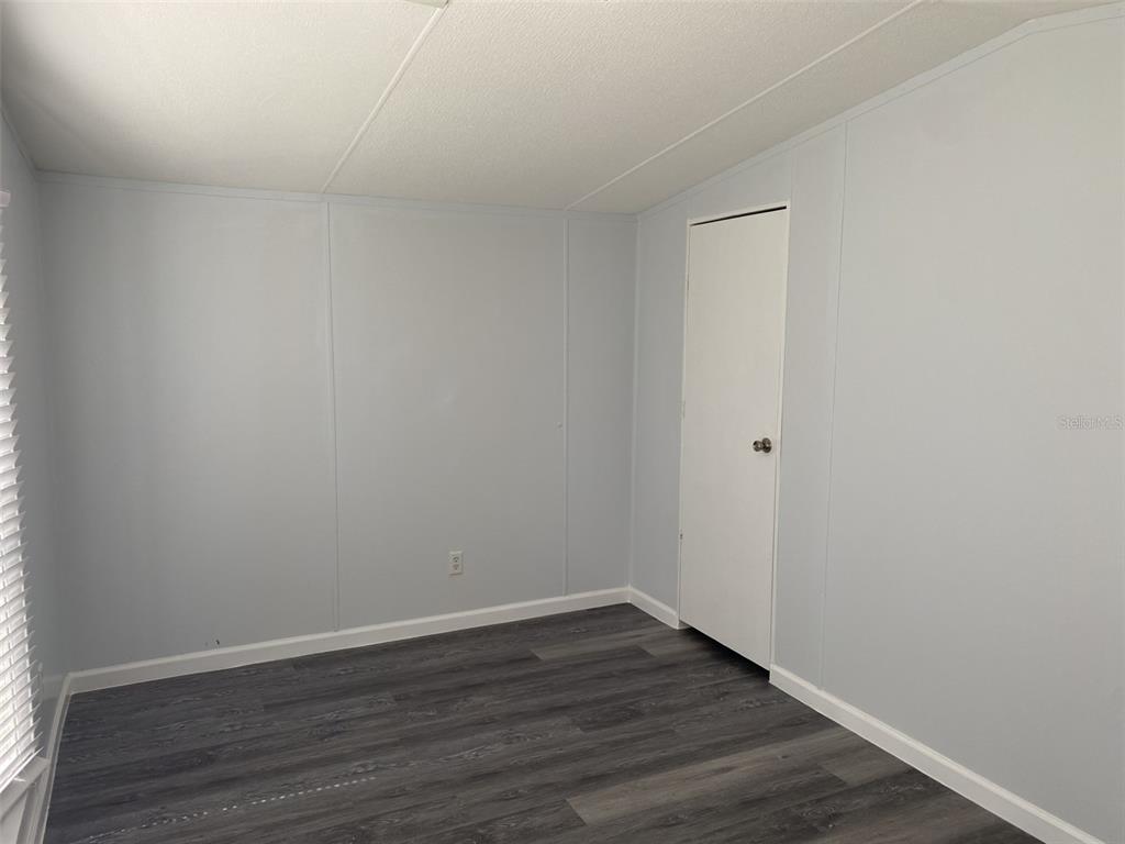 1604 Vintage Street Kissimmee, FL 34746 - Photo 15 of 23 a view of an empty room with wooden floor