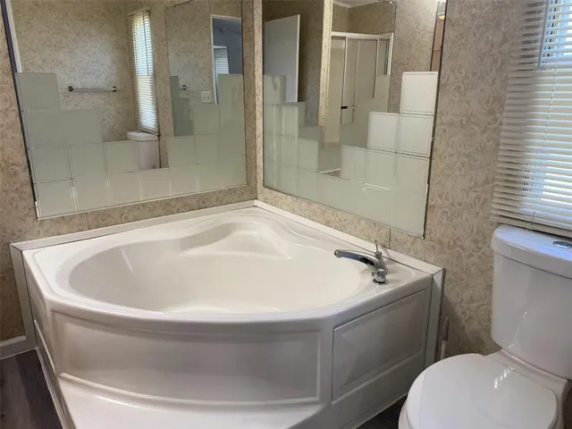 a white bath tub sitting next to a toilet
