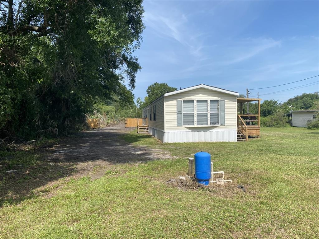 1604 Vintage Street Kissimmee, FL 34746 - Photo 2 of 23 a front view of a house with a yard