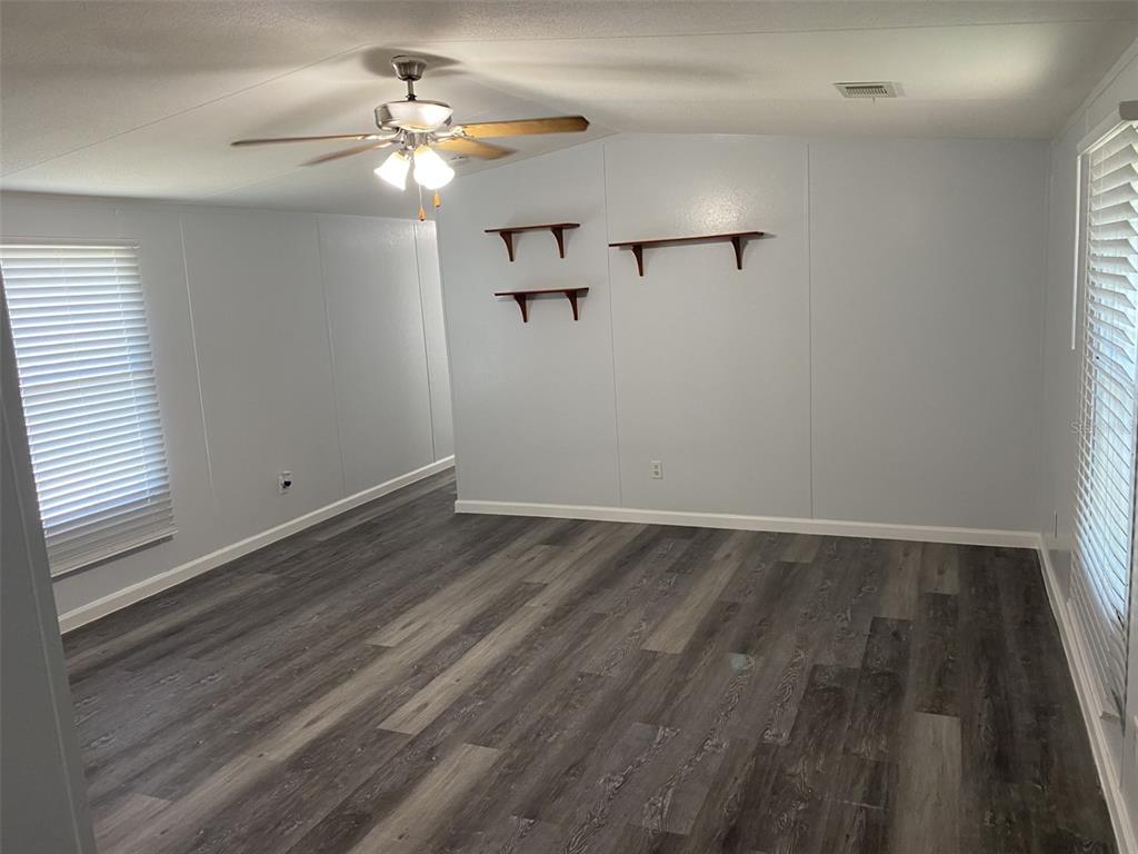 1604 Vintage Street Kissimmee, FL 34746 - Photo 6 of 23 wooden floor in an empty room with a window