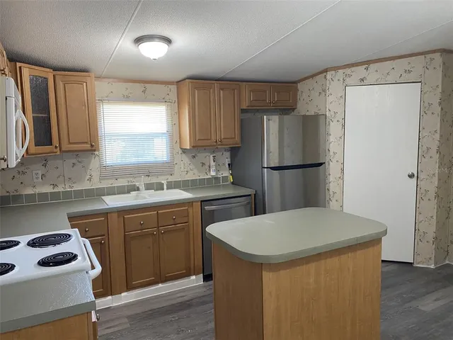 a kitchen with a sink a refrigerator a washer and dryer