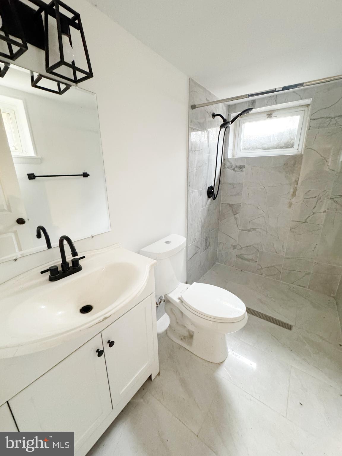 11969 Andrew Street Silver Spring, MD 20902 - Photo 14 of 20 a bathroom with a sink a toilet and shower