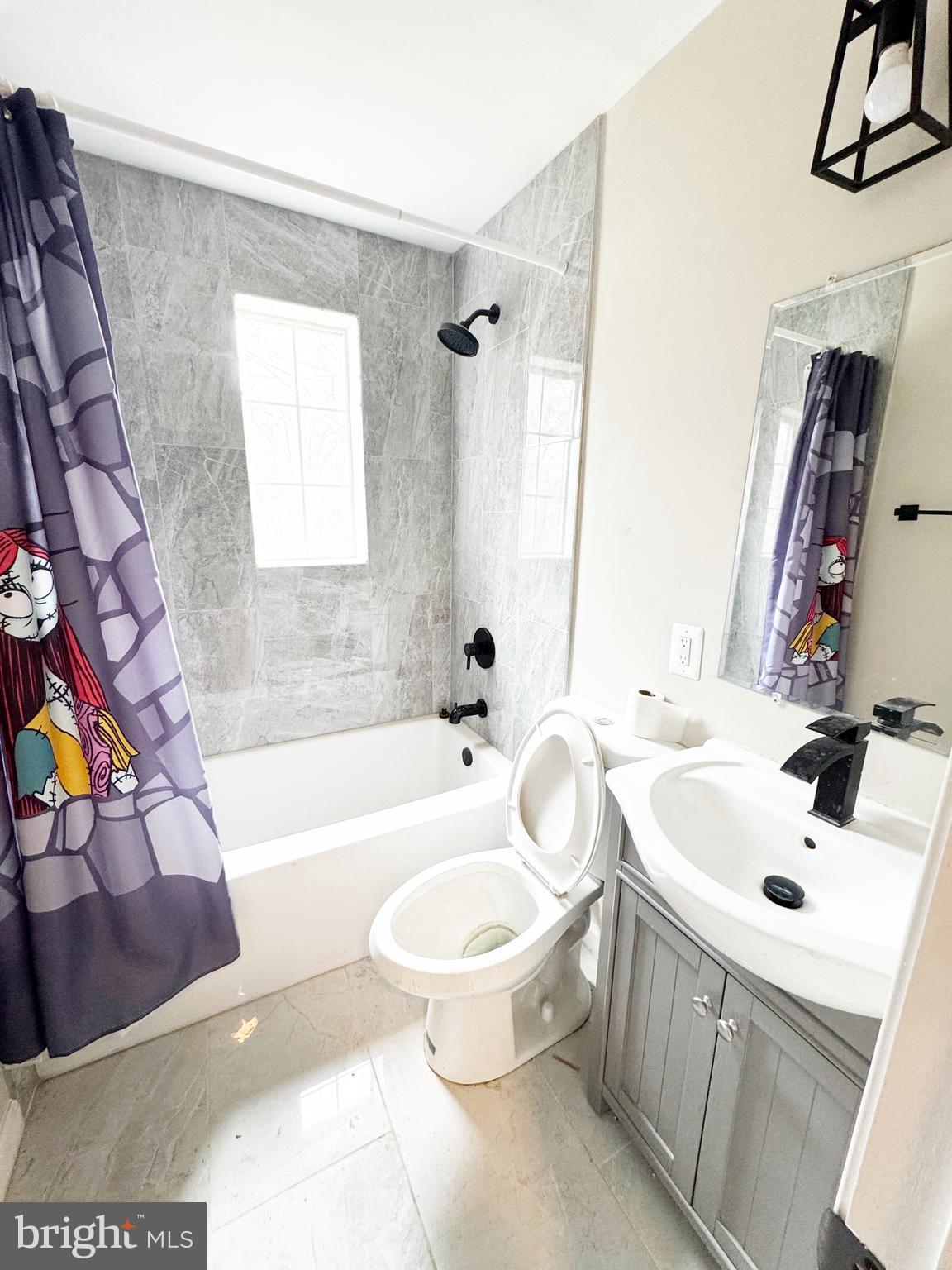 11969 Andrew Street Silver Spring, MD 20902 - Photo 9 of 20 a bathroom with a sink a toilet and a bathtub