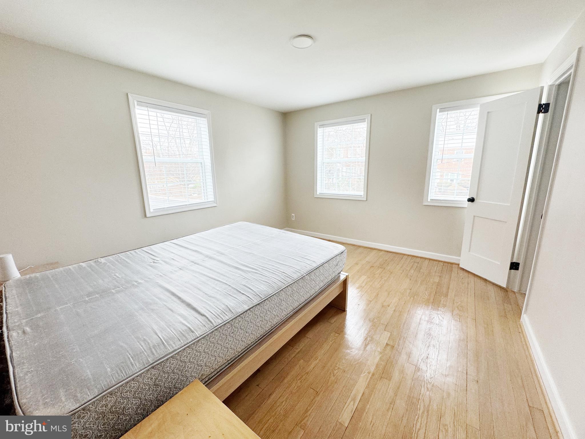 11969 Andrew Street Silver Spring, MD 20902 - Photo 10 of 20 a spacious bedroom with a bed and a window