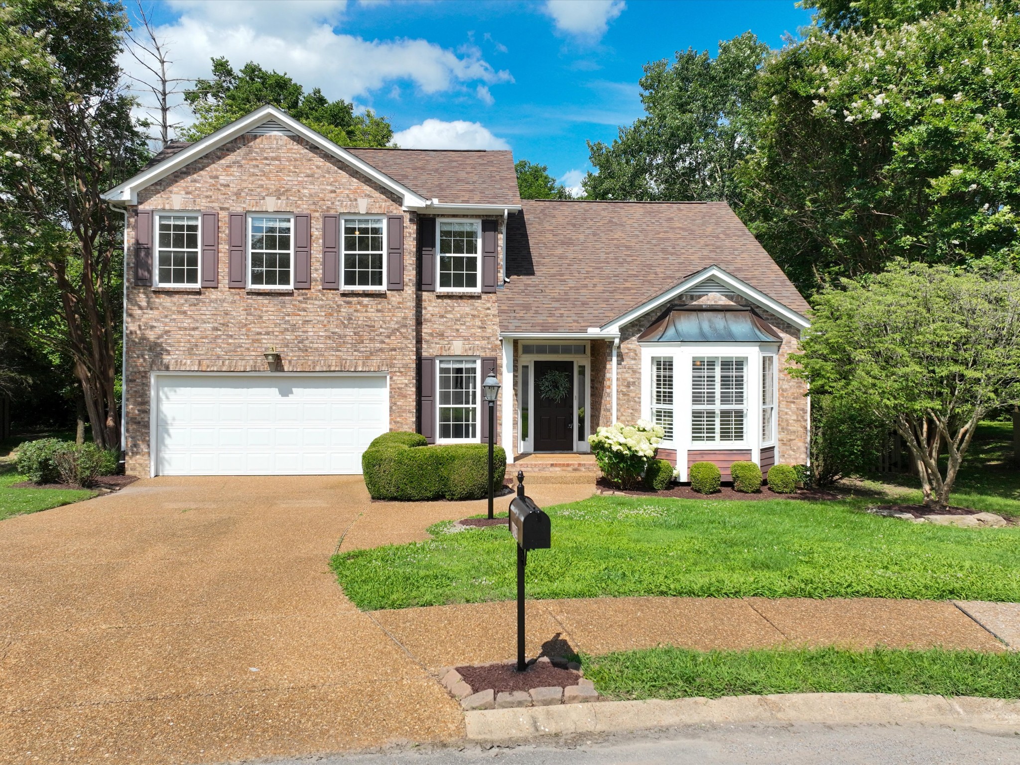4629 Sandy Creek Road Nashville, TN 37221 - Photo 1 of 48 a front view of a house with a yard and garage