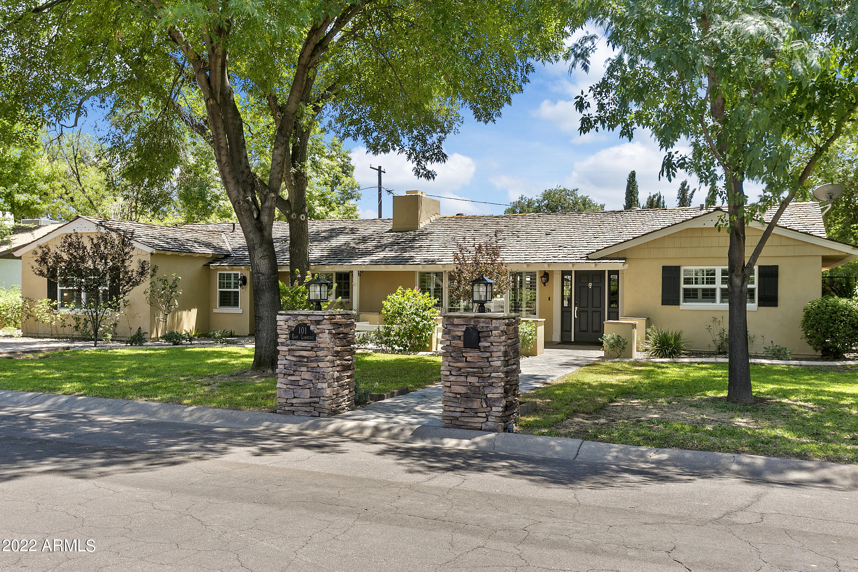 101 East Lawrence Road Phoenix, AZ 85012 - Photo 1 of 48 a front view of a house with garden and trees