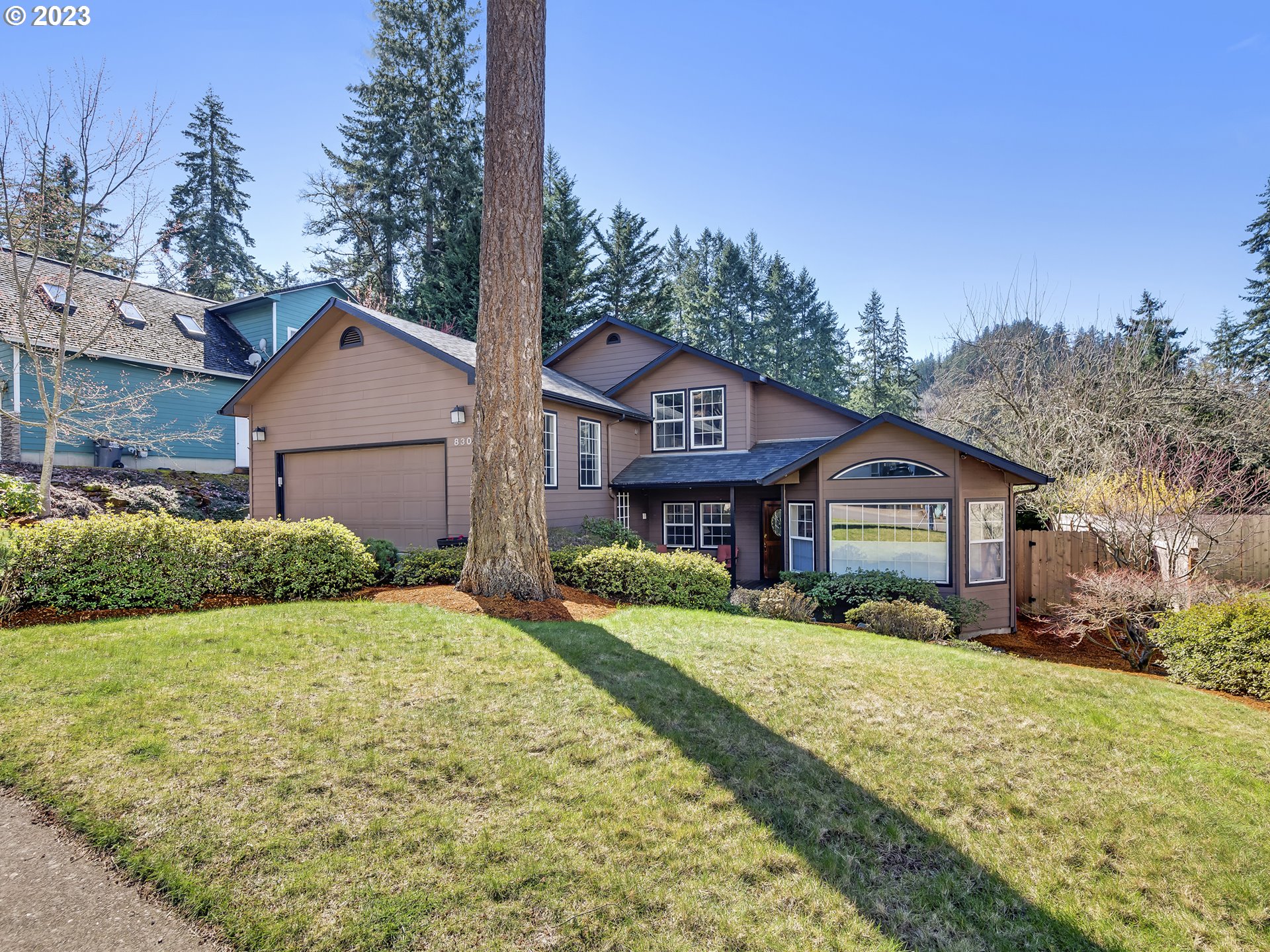 830 South 69th Street Springfield, OR 97478 - Photo 1 of 35 a view of a big house with a big yard and large trees