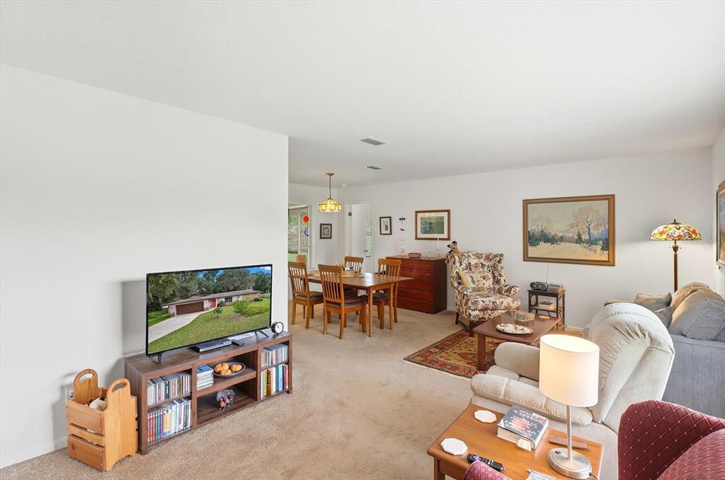 3103 South Bay Berry Point Inverness, FL 34450 - Photo 13 of 50 a living room with furniture and a flat screen tv