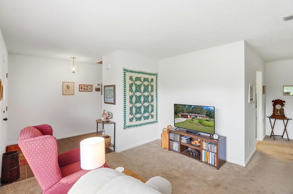 3103 South Bay Berry Point Inverness, FL 34450 - Photo 15 of 50 a living room with furniture and a flat screen tv