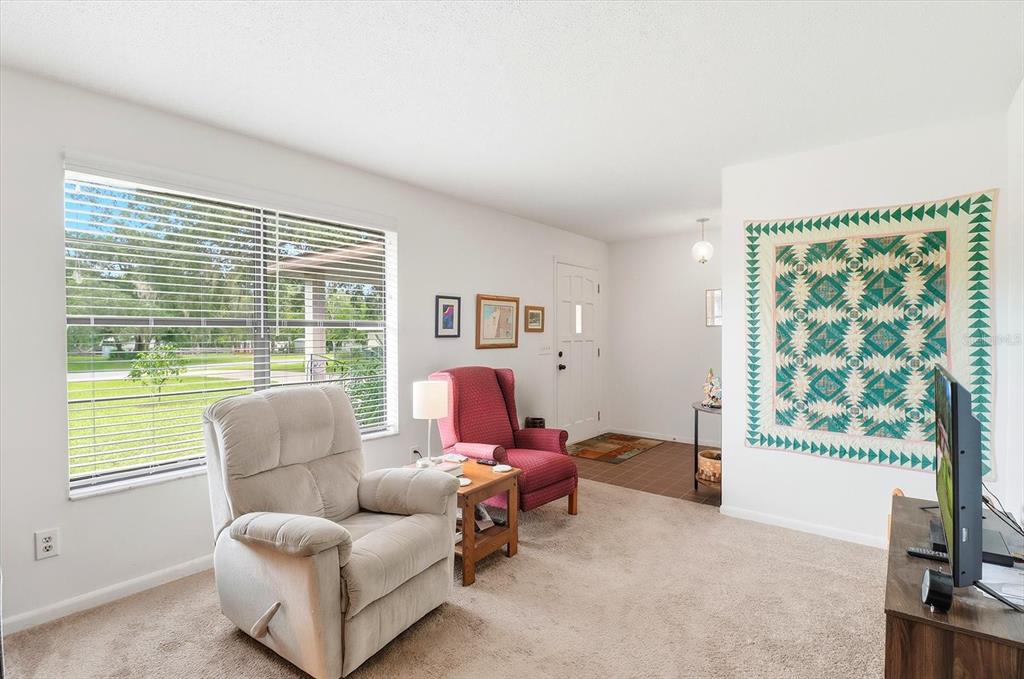 3103 South Bay Berry Point Inverness, FL 34450 - Photo 16 of 50 a living room with furniture and a flat screen tv
