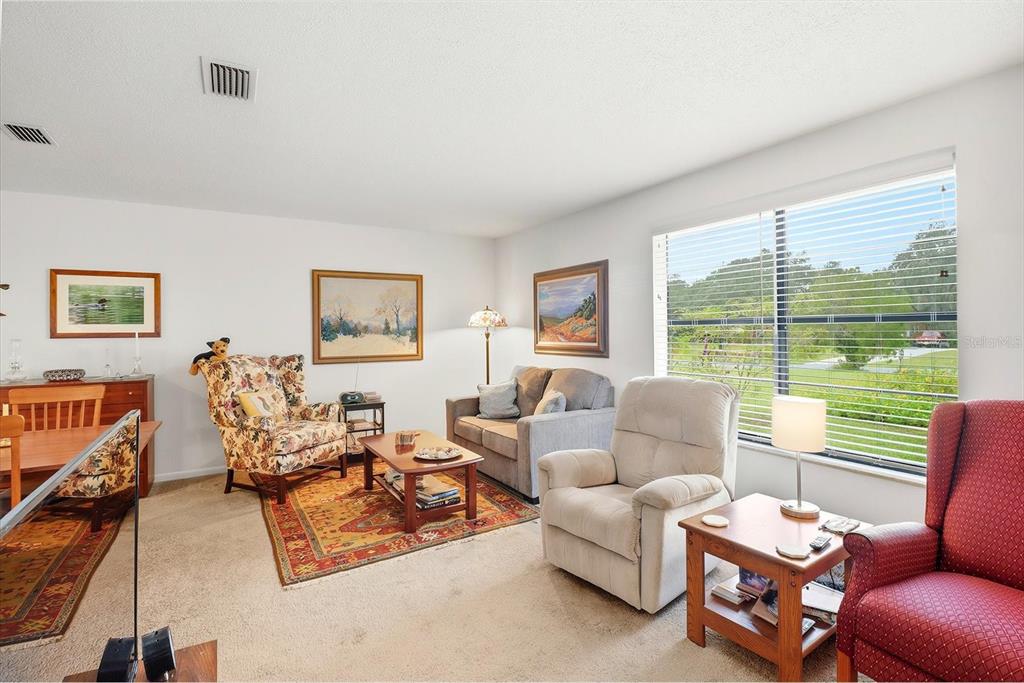 3103 South Bay Berry Point Inverness, FL 34450 - Photo 17 of 50 a living room with furniture and a large window