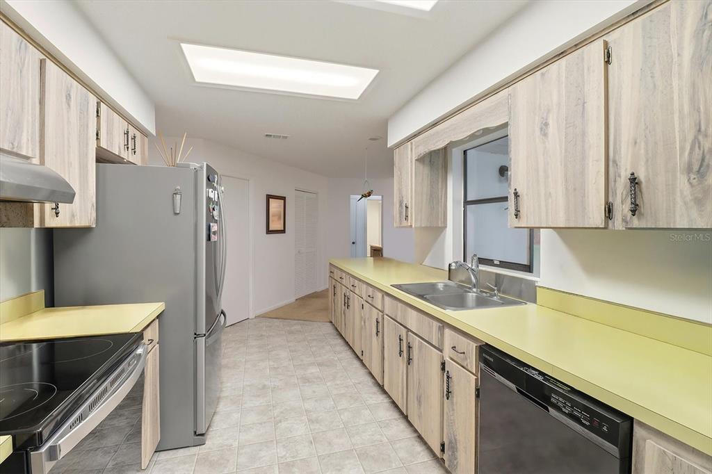 3103 South Bay Berry Point Inverness, FL 34450 - Photo 20 of 50 a kitchen with a sink stove and refrigerator