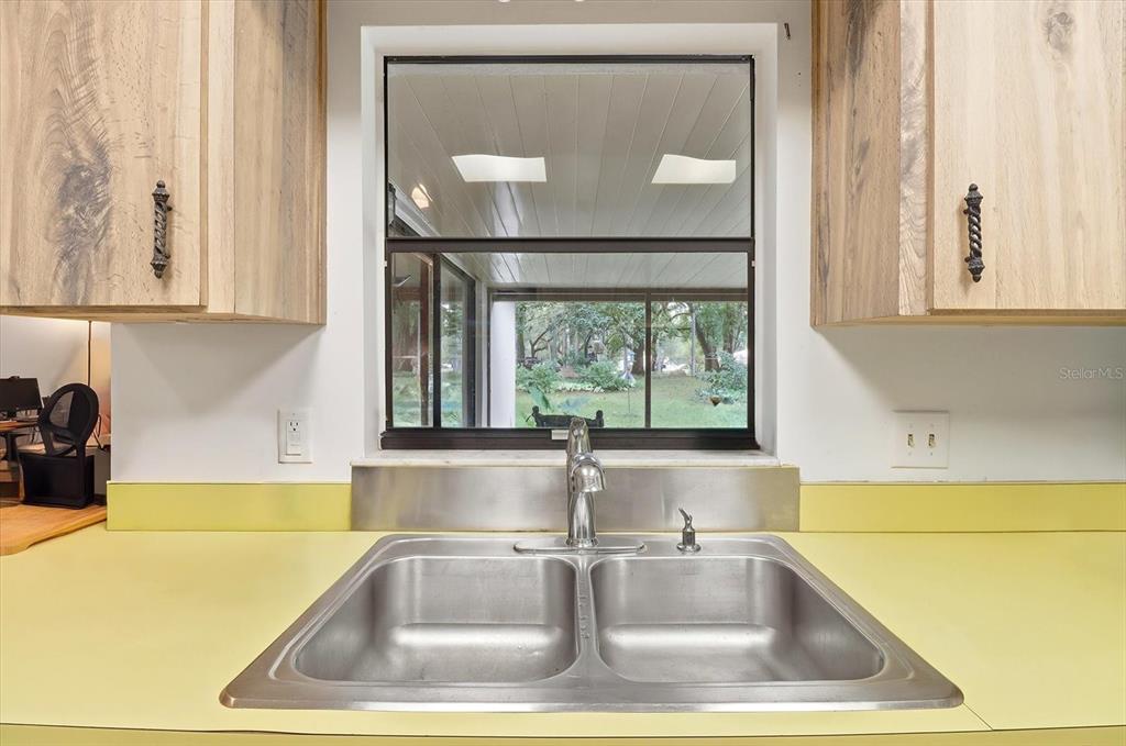 3103 South Bay Berry Point Inverness, FL 34450 - Photo 22 of 50 a view of a sink and dishwasher with a window