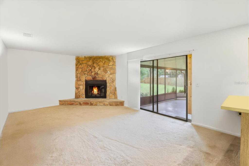 3103 South Bay Berry Point Inverness, FL 34450 - Photo 4 of 50 a view of an empty room with a fireplace and a window