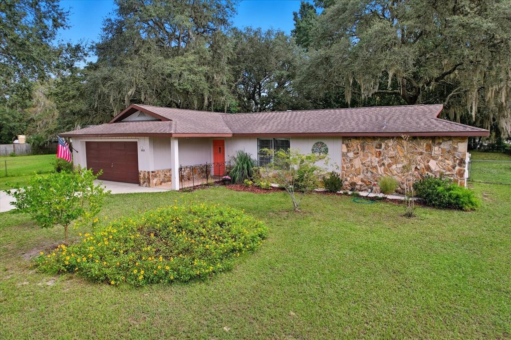 3103 South Bay Berry Point Inverness, FL 34450 - Photo 10 of 50 a front view of a house with garden