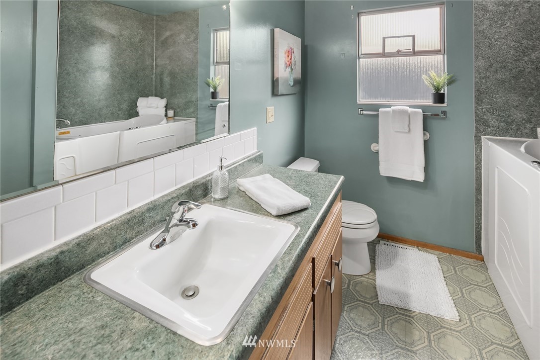 203 Northwest 4th Street Renton, WA 98057 - Photo 17 of 27 a bathroom with a sink toilet and mirror