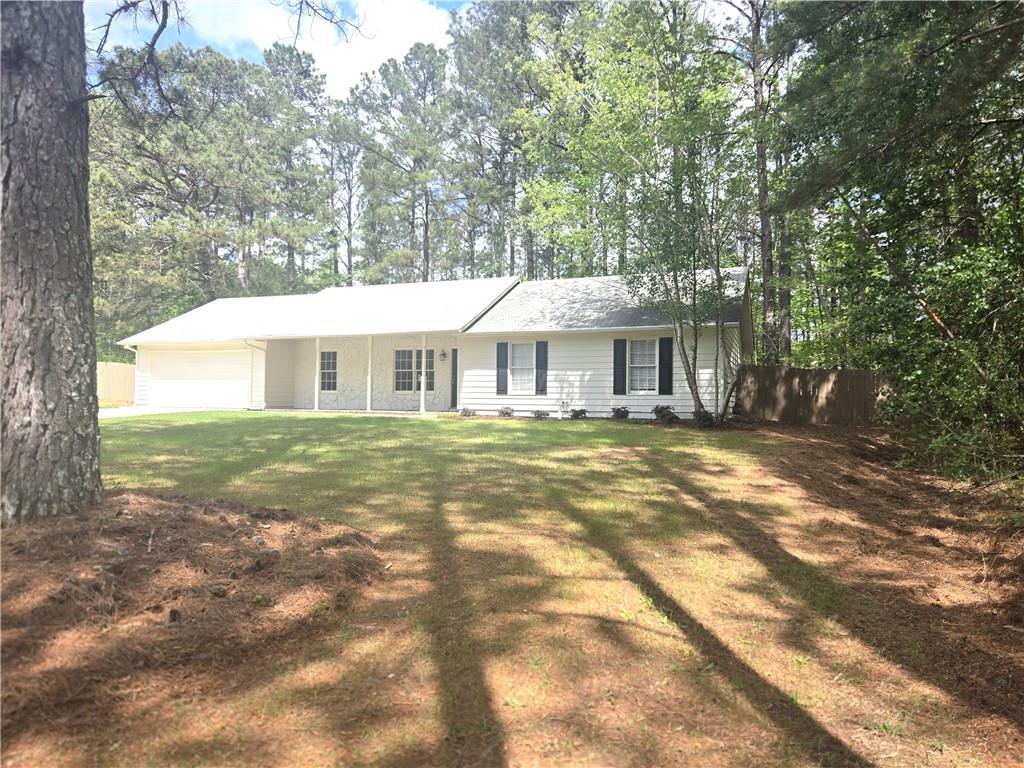 11013 Clearwater Drive Hampton, GA 30228 - Photo 1 of 23 a front view of a house with a garden