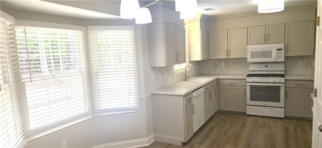 11013 Clearwater Drive Hampton, GA 30228 - Photo 13 of 23 a kitchen with a stove a sink and a window