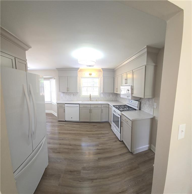 11013 Clearwater Drive Hampton, GA 30228 - Photo 14 of 23 a large kitchen with a wooden floor and a window