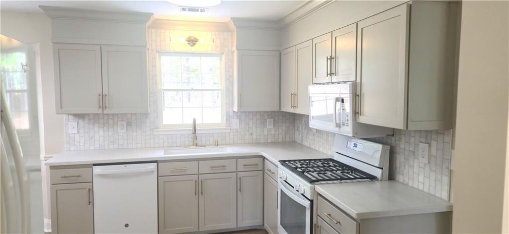 11013 Clearwater Drive Hampton, GA 30228 - Photo 15 of 23 a kitchen with white cabinets and window