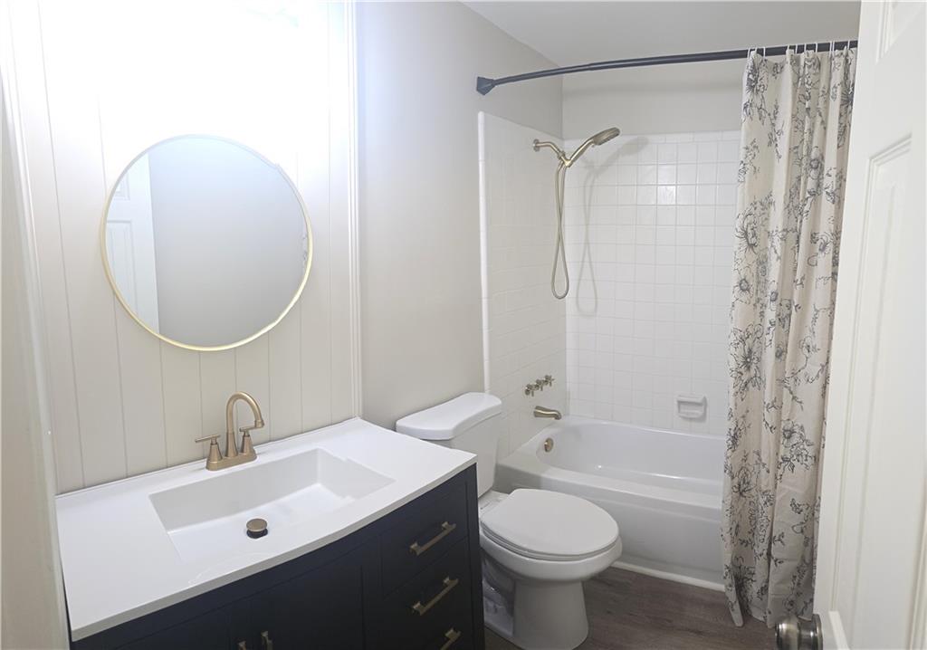 11013 Clearwater Drive Hampton, GA 30228 - Photo 16 of 23 a bathroom with a sink toilet a shower and a mirror