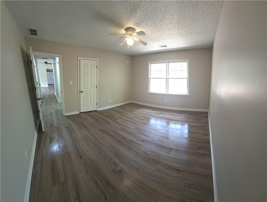 11013 Clearwater Drive Hampton, GA 30228 - Photo 22 of 23 a view of empty room with wooden floor and fan
