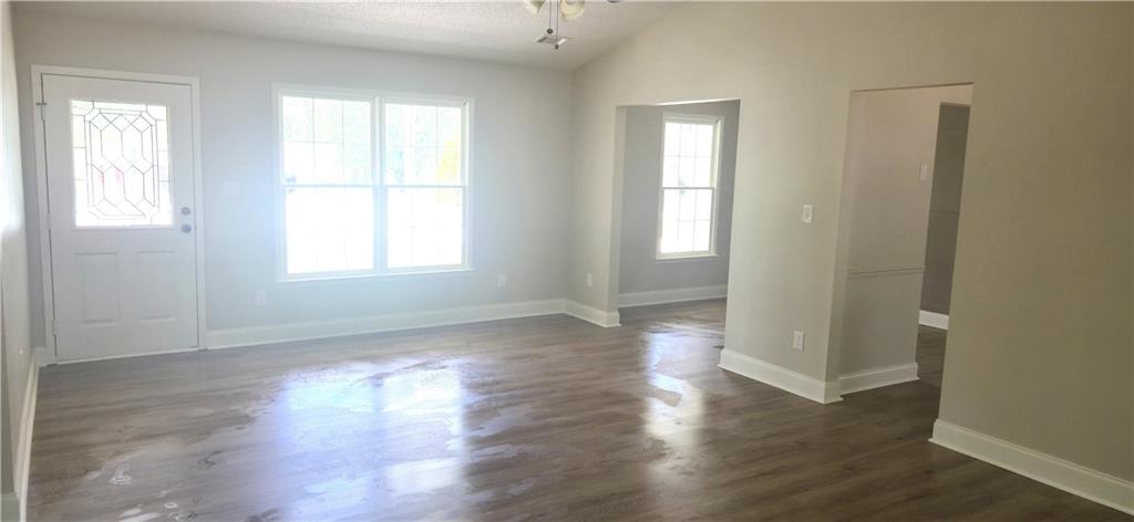 11013 Clearwater Drive Hampton, GA 30228 - Photo 7 of 23 an empty room with wooden floor and windows