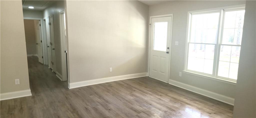 11013 Clearwater Drive Hampton, GA 30228 - Photo 8 of 23 an empty room with wooden floor and windows