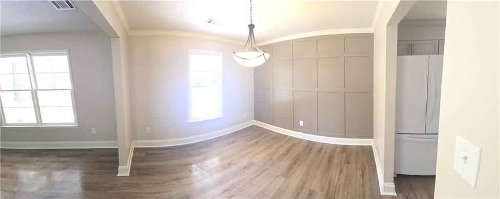 11013 Clearwater Drive Hampton, GA 30228 - Photo 9 of 23 an empty room with wooden floor and windows
