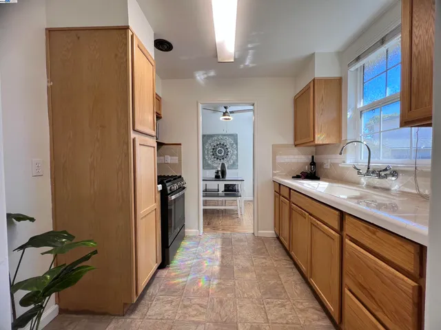 a open kitchen with stainless steel appliances granite countertop a refrigerator and a sink