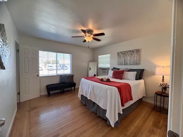 a bedroom with bed and a chandelier