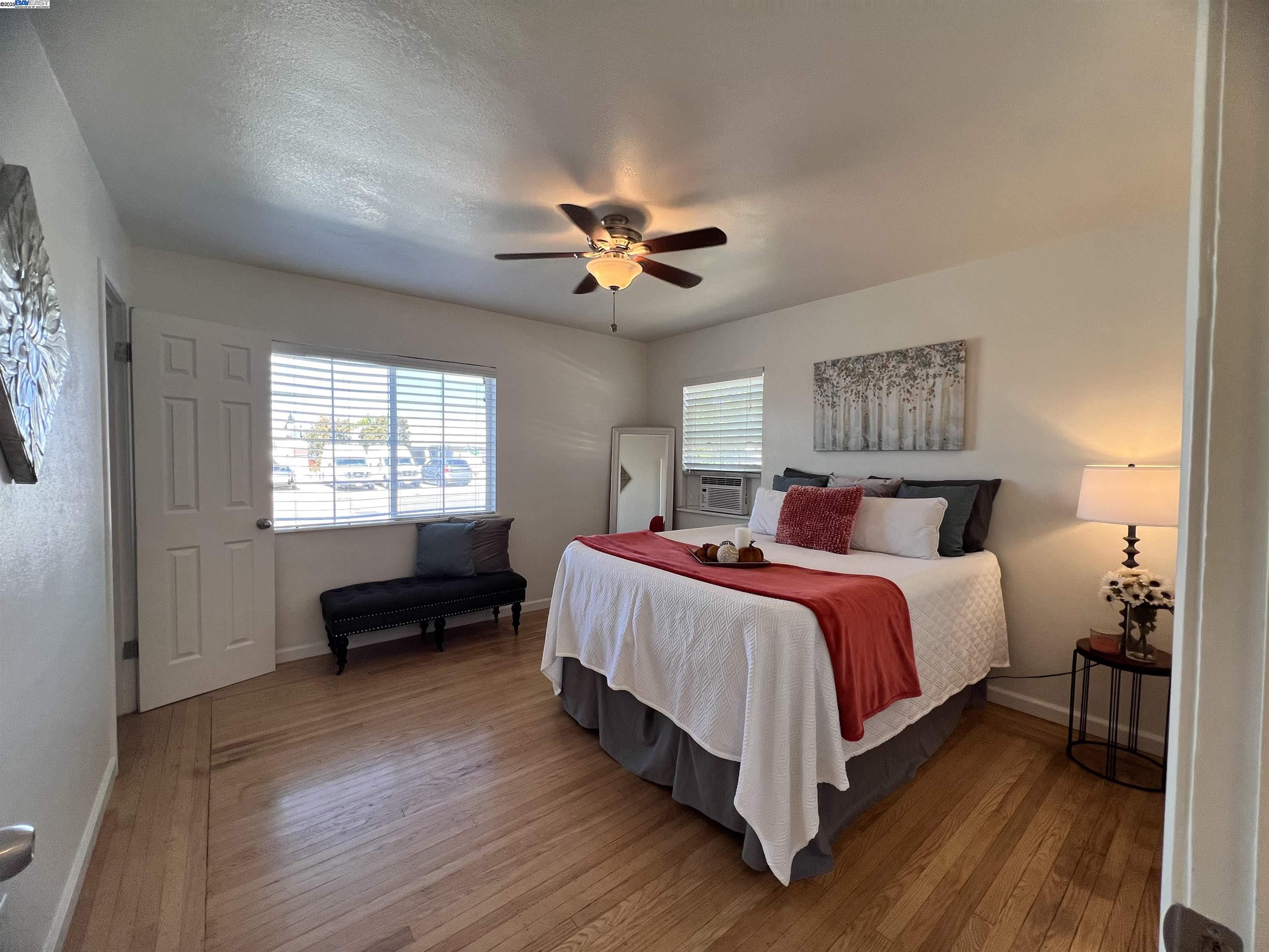 1727 Second Street Livermore, CA 94550 - Photo 14 of 24 a bedroom with bed and a chandelier