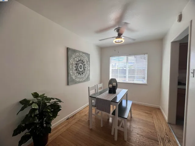 a workspace with wooden floor and a window