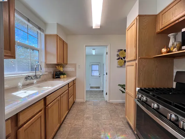 a kitchen with a sink stove and refrigerator