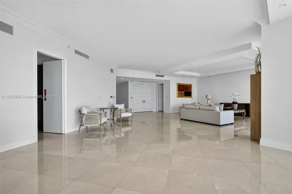 a view of a dining room with furniture and a window